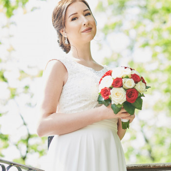 Портрет невесты с букетом красно-белых роз в ярком дневном свете, легкая улыбка и нежный образ., фото - фотограф Дмтрий Покидин
